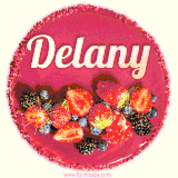 Beautifully decorated red velvet berry birthday cake with vibrant fruits and a glowing 'Delany' name, adding a touch of sweetness and sparkle.