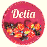 Beautifully decorated red velvet berry birthday cake with vibrant fruits and a glowing 'Delia' name, adding a touch of sweetness and sparkle.