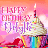 A vibrant birthday GIF featuring a rainbow-colored cupcake topped with white frosting, sprinkles, and a lit candle. The text reads 'Happy Birthday Delyth' in bold pink and violet letters with white outline.