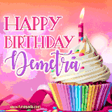 A vibrant birthday GIF featuring a rainbow-colored cupcake topped with white frosting, sprinkles, and a lit candle. The text reads 'Happy Birthday Demetra' in bold pink and violet letters with white outline.
