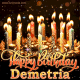 A glowing personalized birthday GIF with name Demetria featuring lit candles with intricate designs, warm lighting, and the text 'Happy Birthday' in an elegant font.