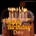A rich chocolate cake topped with glowing birthday candles and surrounded by bright fireworks. The animated GIF displays the message 'Happy Birthday Dev' in golden text.