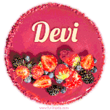 Beautifully decorated red velvet berry birthday cake with vibrant fruits and a glowing 'Devi' name, adding a touch of sweetness and sparkle.