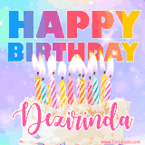 A vibrant animated name GIF with the words 'Happy Birthday Dezirinda' with colorful candles on a creamy cake. The background sparkles with pastel shades, adding a festive touch.