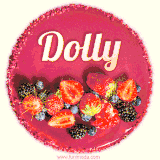 Beautifully decorated red velvet berry birthday cake with vibrant fruits and a glowing 'Dolly' name, adding a touch of sweetness and sparkle.