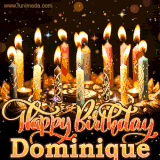 A glowing personalized birthday GIF with name Dominique featuring lit candles with intricate designs, warm lighting, and the text 'Happy Birthday' in an elegant font.