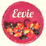Beautifully decorated red velvet berry birthday cake with vibrant fruits and a glowing 'Eevie' name, adding a touch of sweetness and sparkle.