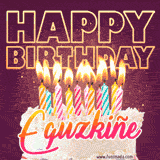 A colorful birthday cake topped with lit candles, with the words 'Happy Birthday Eguzkiñe' in bold glowing letters on a burgundy background. Animated flames add a festive touch.