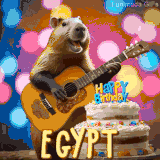 Animated birthday GIF showing a capybara playing guitar and singing beside a birthday cake with the name Egypt in large letters and colorful bokeh lights in the background.