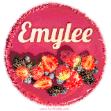 Beautifully decorated red velvet berry birthday cake with vibrant fruits and a glowing 'Emylee' name, adding a touch of sweetness and sparkle.