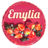 Beautifully decorated red velvet berry birthday cake with vibrant fruits and a glowing 'Emylia' name, adding a touch of sweetness and sparkle.