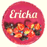Beautifully decorated red velvet berry birthday cake with vibrant fruits and a glowing 'Ericka' name, adding a touch of sweetness and sparkle.