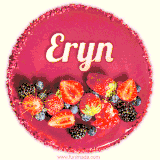 Beautifully decorated red velvet berry birthday cake with vibrant fruits and a glowing 'Eryn' name, adding a touch of sweetness and sparkle.