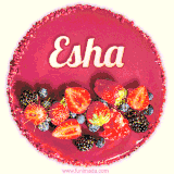 Beautifully decorated red velvet berry birthday cake with vibrant fruits and a glowing 'Esha' name, adding a touch of sweetness and sparkle.