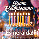 Birthday cake topped with pink and yellow lit candles, surrounded by glowing bokeh lights and party balloons. The greeting 'Buon Compleanno Esmeralda GIF!' is displayed.