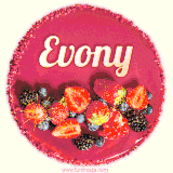 Beautifully decorated red velvet berry birthday cake with vibrant fruits and a glowing 'Evony' name, adding a touch of sweetness and sparkle.
