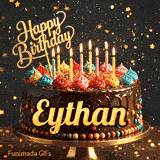 A gourmet chocolate cake on a stand with burning candles and a gold Happy Birthday topper, made for Eythan.