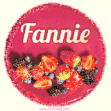 Beautifully decorated red velvet berry birthday cake with vibrant fruits and a glowing 'Fannie' name, adding a touch of sweetness and sparkle.