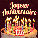 A Happy Birthday GIF in French featuring a festive birthday cake adorned with bright candles and the glowing text 'Joyeux Anniversaire Fin' in a cheerful style.