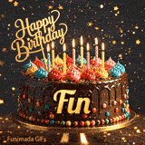 Shimmering gold stars and bokeh lights surround a chocolate drip cake personalized with the name Fin.