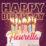 A colorful birthday cake topped with lit candles, with the words 'Happy Birthday Fleuretta' in bold glowing letters on a burgundy background. Animated flames add a festive touch.
