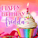 A vibrant birthday GIF featuring a rainbow-colored cupcake topped with white frosting, sprinkles, and a lit candle. The text reads 'Happy Birthday Fredda' in bold pink and violet letters with white outline.