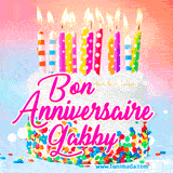 A white birthday cake covered in colorful sprinkles, topped with bright candles, and French text 'Bon Anniversaire Gabby' on a pastel gradient background in an animated GIF.