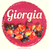Beautifully decorated red velvet berry birthday cake with vibrant fruits and a glowing 'Giorgia' name, adding a touch of sweetness and sparkle.