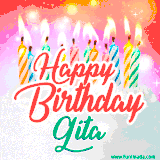 Bright birthday candles with rainbow flames on a cake, alongside the text 'Happy Birthday Gita' in vibrant script in this celebratory animated GIF.