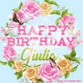 A charming animated GIF featuring 'Happy Birthday Giulia' in pink and green text, surrounded by delicate roses, leaves, and fluttering butterflies on a soft light blue pastel background.