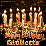 A glowing personalized birthday GIF with name Giulietta featuring lit candles with intricate designs, warm lighting, and the text 'Happy Birthday' in an elegant font.