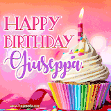 A vibrant birthday GIF featuring a rainbow-colored cupcake topped with white frosting, sprinkles, and a lit candle. The text reads 'Happy Birthday Giuseppa' in bold pink and violet letters with white outline.