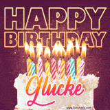 A colorful birthday cake topped with lit candles, with the words 'Happy Birthday Glucke' in bold glowing letters on a burgundy background. Animated flames add a festive touch.