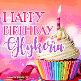 A vibrant birthday GIF featuring a rainbow-colored cupcake topped with white frosting, sprinkles, and a lit candle. The text reads 'Happy Birthday Glykeria' in bold pink and violet letters with white outline.
