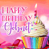 A vibrant birthday GIF featuring a rainbow-colored cupcake topped with white frosting, sprinkles, and a lit candle. The text reads 'Happy Birthday Gobnet' in bold pink and violet letters with white outline.