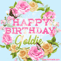 A charming animated GIF featuring 'Happy Birthday Goldie' in pink and green text, surrounded by delicate roses, leaves, and fluttering butterflies on a soft light blue pastel background.