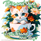 A kitten peeking out of a teacup surrounded by flowers with the text 'Rise and shine, it’s a brand new day!' in an artistic font.