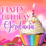 A vibrant birthday GIF featuring a rainbow-colored cupcake topped with white frosting, sprinkles, and a lit candle. The text reads 'Happy Birthday Gordana' in bold pink and violet letters with white outline.