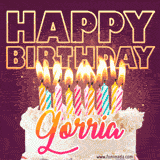 A colorful birthday cake topped with lit candles, with the words 'Happy Birthday Gorria' in bold glowing letters on a burgundy background. Animated flames add a festive touch.