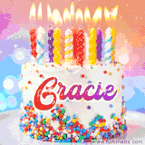 A cheerful white birthday cake with multicolor sprinkles, lit candles, and 'Gracie' written in vibrant letters, in an animated GIF.