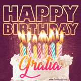 A colorful birthday cake topped with lit candles, with the words 'Happy Birthday Gratia' in bold glowing letters on a burgundy background. Animated flames add a festive touch.