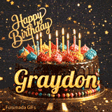 Gold Happy Birthday topper and bright burning candles on a chocolate frosted cake with the name Graydon.