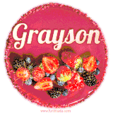 Beautifully decorated red velvet berry birthday cake with vibrant fruits and a glowing 'Grayson' name, adding a touch of sweetness and sparkle.
