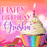 A vibrant birthday GIF featuring a rainbow-colored cupcake topped with white frosting, sprinkles, and a lit candle. The text reads 'Happy Birthday Grusha' in bold pink and violet letters with white outline.