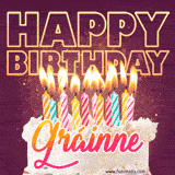 A colorful birthday cake topped with lit candles, with the words 'Happy Birthday Gráinne' in bold glowing letters on a burgundy background. Animated flames add a festive touch.