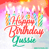 Bright birthday candles with rainbow flames on a cake, alongside the text 'Happy Birthday Gussie' in vibrant script in this celebratory animated GIF.