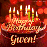 Beautifully decorated red velvet berry birthday cake with vibrant fruits and a glowing 'Gwen' name, adding a touch of sweetness and sparkle.