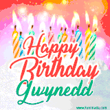 Bright birthday candles with rainbow flames on a cake, alongside the text 'Happy Birthday Gwynedd' in vibrant script in this celebratory animated GIF.