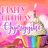 A vibrant birthday GIF featuring a rainbow-colored cupcake topped with white frosting, sprinkles, and a lit candle. The text reads 'Happy Birthday Györgyike' in bold pink and violet letters with white outline.