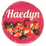 Beautifully decorated red velvet berry birthday cake with vibrant fruits and a glowing 'Haedyn' name, adding a touch of sweetness and sparkle.